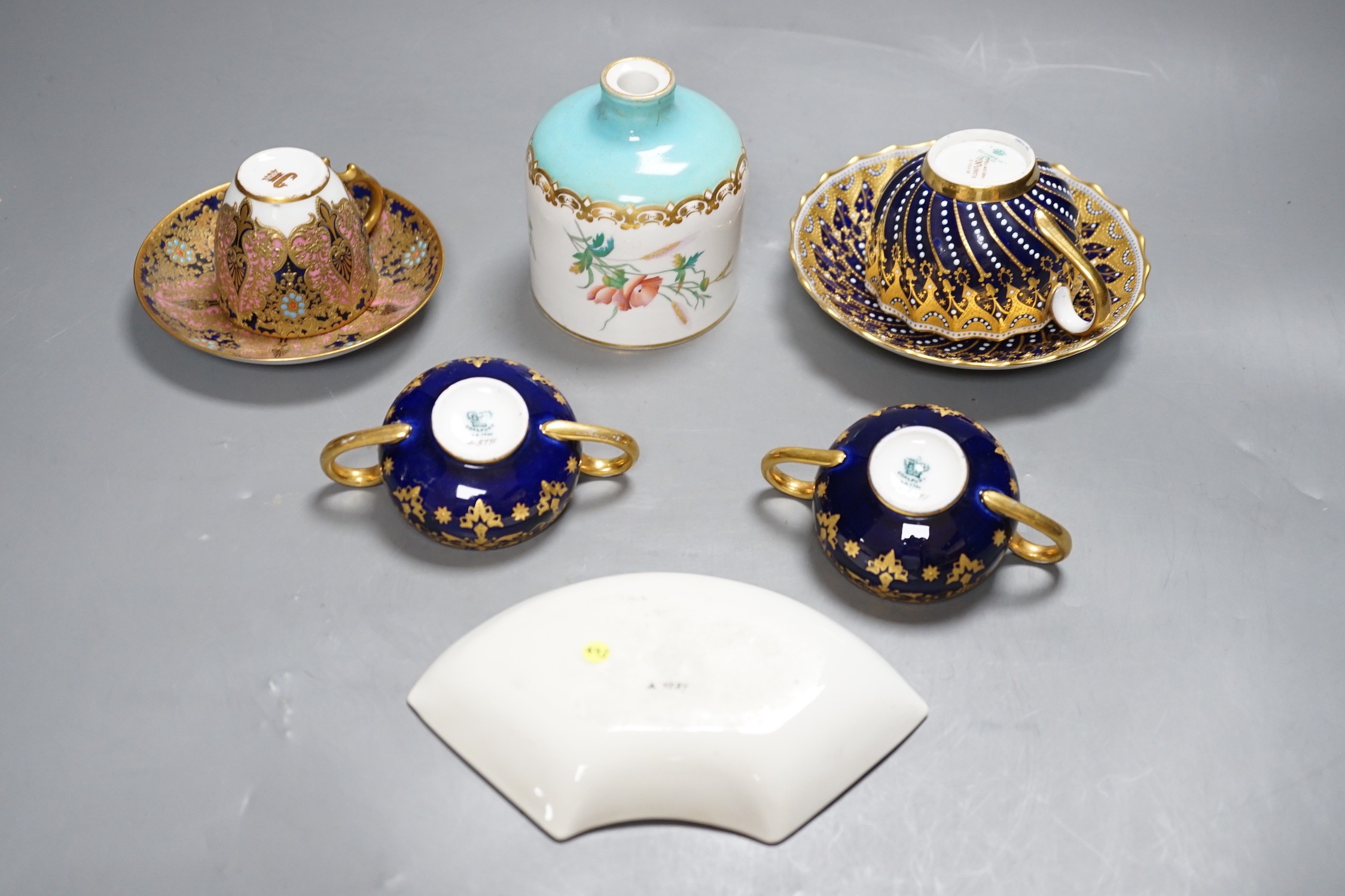 A 19th century Coalport fan shaped dish painted with a Loch scene, two small cup with twin handles decorated with raised gilding on a cobalt blue ground with crown marks, a Copeland jewelled cup and saucer with blue grou